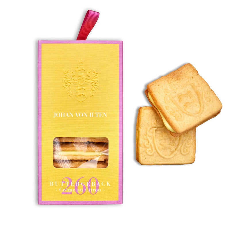 Buttergebäck Crème au Citron in der Verpackung, daneben zwei Kekse